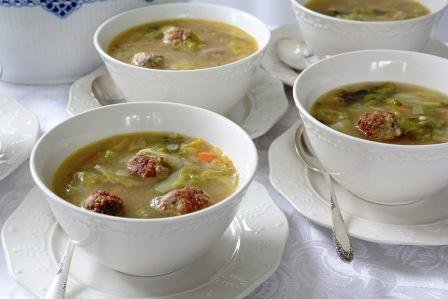 Italian wedding soup plated in white bowls