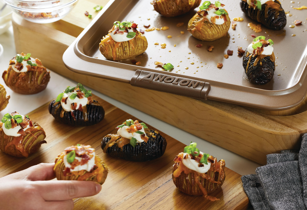 loaded mini hasselback potatoes on an Anolon baking sheet