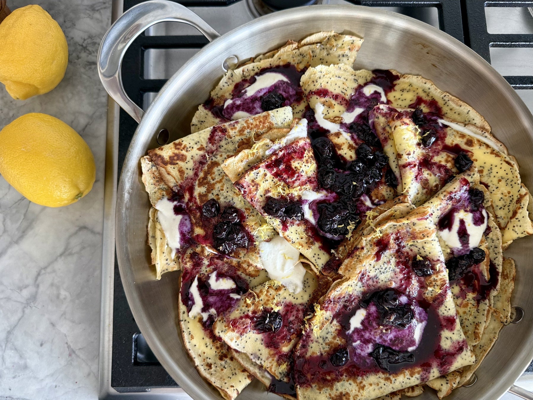 Lemon Poppyseed Crepes Stuffed with Whipped Lemon Ricotta Filling and Topped with Blueberry Compote