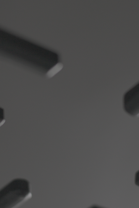 A short, looping GIF showing an Anolon X frying pan being placed onto a stovetop. The camera focuses on the base of the pan as it makes contact with the burner, highlighting the pan's heavy-duty construction and its compatibility with all cooktops, including induction.