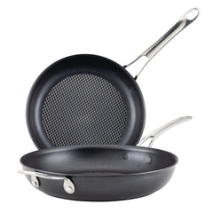 Discover the AnolonX 10-Inch and 12-Inch Hybrid Nonstick Frying Pan Set, designed with stainless steel handles for an elegant touch. These pans are ideal for induction cooking, featuring a sleek, dark finish complemented by a durable stainless steel mesh. One pan is positioned upright to display its textured surface, while the other rests flat below it.