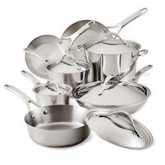 The Nouvelle Stainless 12-Piece Cookware Set is elegantly displayed, showcasing a range of induction-ready stainless steel pots and pans complete with matching lids. The polished handles and the sleek, modern design make this set ideal for gourmet cooking, shining beautifully as they reflect light off their surfaces.