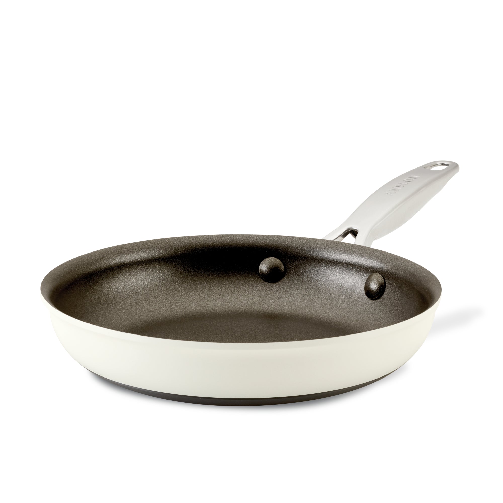 A non-stick frying pan with a white exterior and a dark interior, featuring a silver handle, is shown against a plain white background.