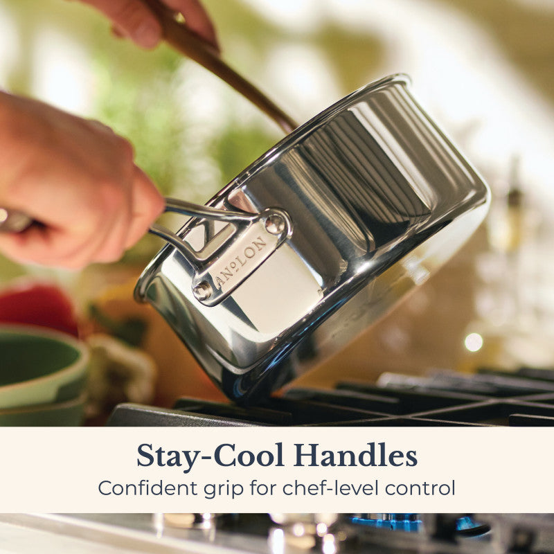 A person holds an EverLast Tri-Ply Clad Stainless Steel saucepan with stay-cool handles over a stove. Text: Stay-Cool Handles for confident, chef-level control. Part of our 10-Piece Cookware Set.