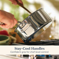 A person holds an EverLast Tri-Ply Clad Stainless Steel 3-Quart Saucepan with Lid over a stove. Text reads: Stay-Cool Handles—confident, comfortable grip for better cookware control.