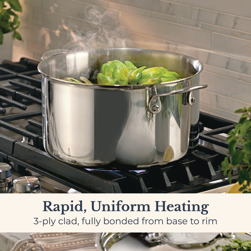 An EverLast Tri-Ply Clad Stainless Steel 8-Quart Stockpot with Lid steams green vegetables on a gas stove. Caption: Rapid, uniform heating with fully bonded 3-ply construction from base to rim.