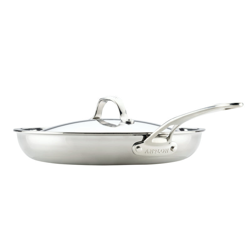 The EverLast Tri-Ply Clad Stainless Steel 12.5-Inch Frying Pan with Lid and Helper Handle, shown in a side view on a white background, is the perfect cookware choice for any passionate home chef.