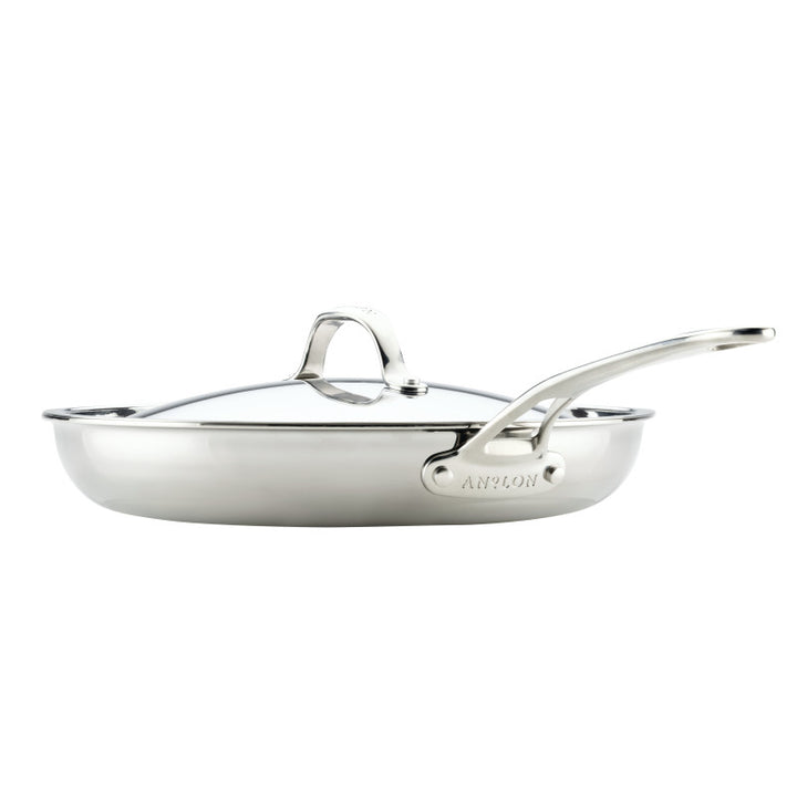 The EverLast Tri-Ply Clad Stainless Steel 12.5-Inch Frying Pan with Lid and Helper Handle, shown in a side view on a white background, is the perfect cookware choice for any passionate home chef.