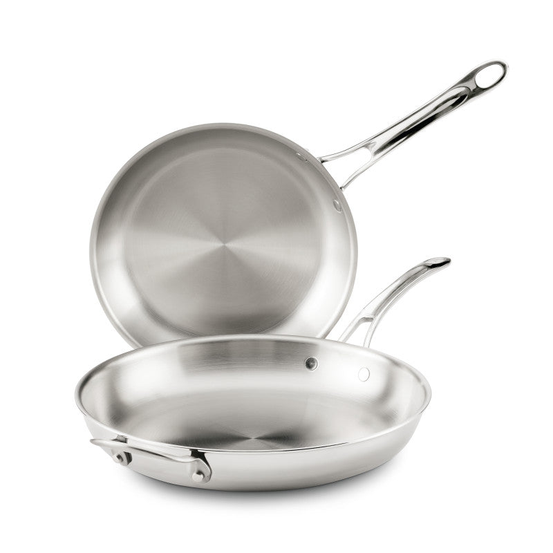 Two EverLast Tri-Ply Clad Stainless Steel Frying Pan Set pans, both with metal handles and a sleek brushed finish—one flat, one upright—make stylish, modern cookware for any kitchen.