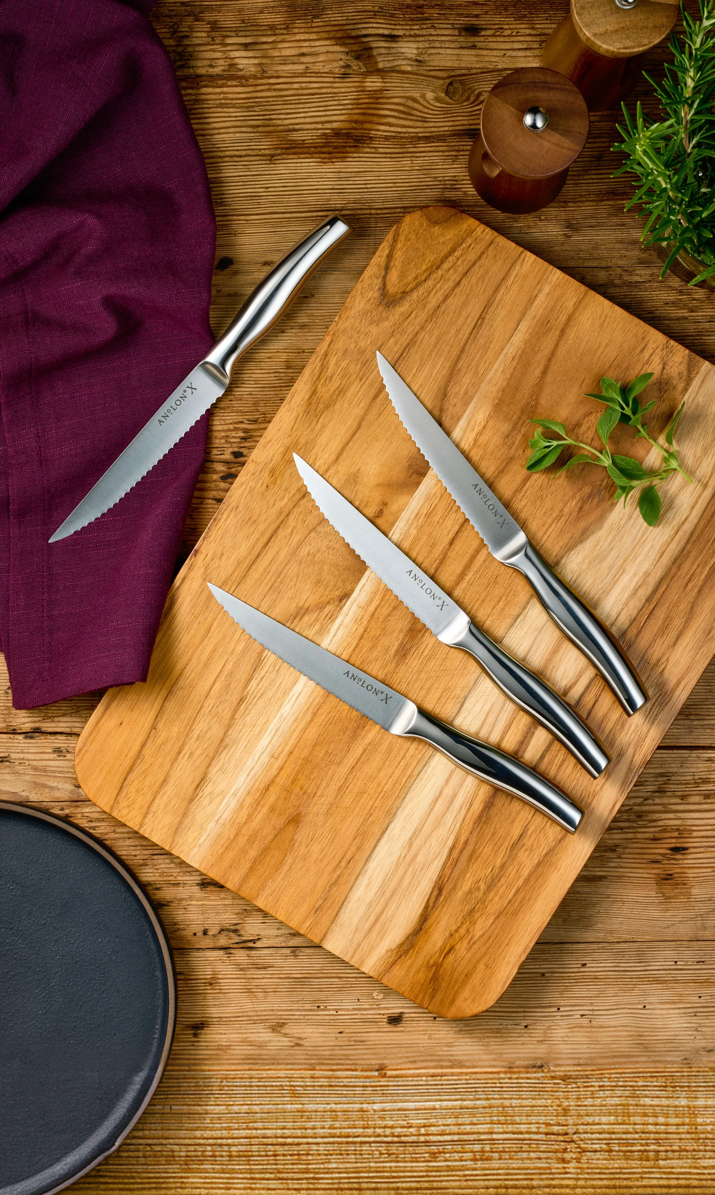 Set of 4 steak knives on teak cutting board