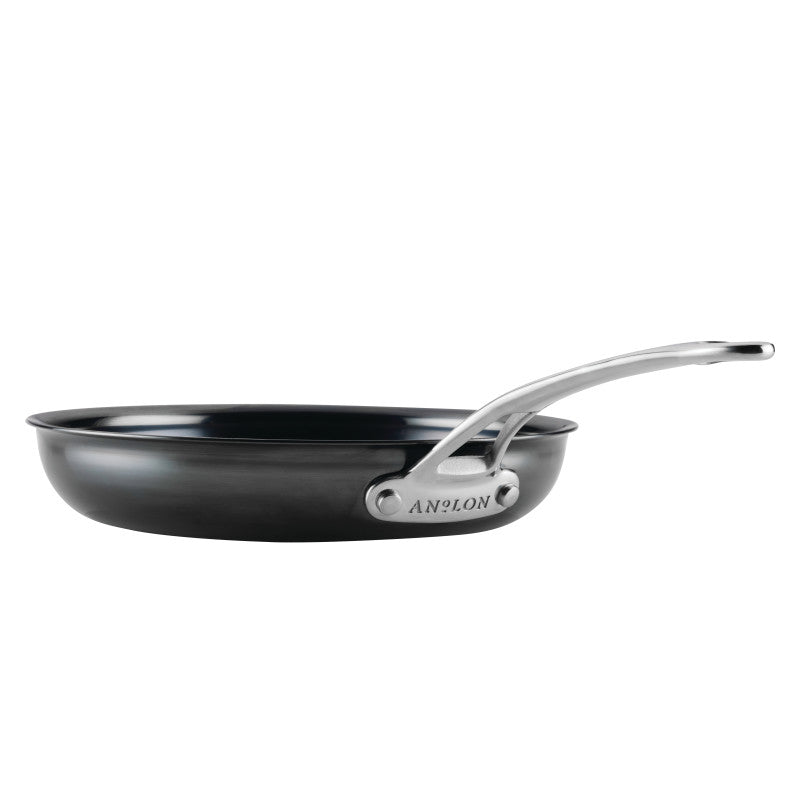 The 10-Inch N₂ Carbon Steel Frying Pan by N₂ Carbon Steel, shown in black with a shiny silver handle and a durable nonstick patina, is viewed from the side against a white background.