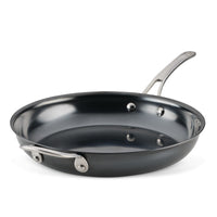 The 12-Inch N₂ Carbon Steel Frying Pan by N₂ Carbon Steel features nitriding technology, a shiny nonstick surface, and both a stainless steel handle and a helper handle, shown against a white background.