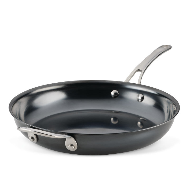 The 12-Inch N2 Carbon Steel Frying Pan by N2 Carbon Steel features a shiny, non-stick nitrided interior, a long metal handle, and is shown on a white background.
