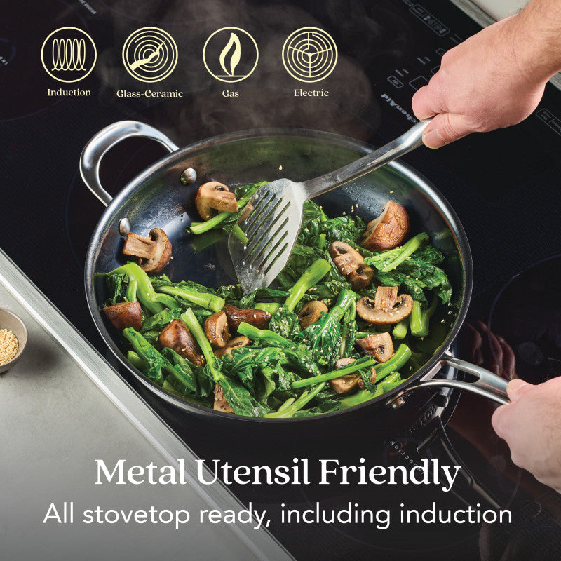 A person cooks leafy greens and mushrooms with a metal spatula in the 12-Inch N₂ Carbon Steel Frying Pan, featuring a naturally evolving nonstick. Icons show its compatible with induction, glass-ceramic, gas, and electric cooktops. Text: Metal Utensil Friendly.