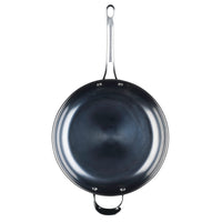 The 12-Inch N2 Carbon Steel Frying Pan by N2 Carbon Steel features a long handle and a smaller helper handle, displaying its sleek, durable finish in a top-down view against a white background.