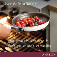 A hand holding a white skillet with cherry tomatoes, placing it in an oven. Text on the image reads, Oven Safe to 500° F and goes from stove to oven to table for ultimate versatility.