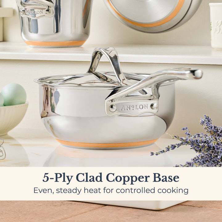 A Nouvelle Stainless 2.5-Quart Saucier with Lid featuring a 5-ply clad copper base sits on a kitchen counter near eggs and lavender. Text: Optimum heat control for controlled cooking.