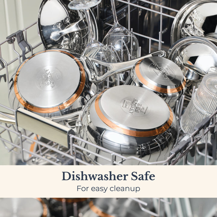 Open dishwasher filled with sparkling Nouvelle Stainless 2.5-Quart Saucier with Lid, pans, utensils, and glassware. Text overlay reads: “Dishwasher Safe for easy cleanup.”.