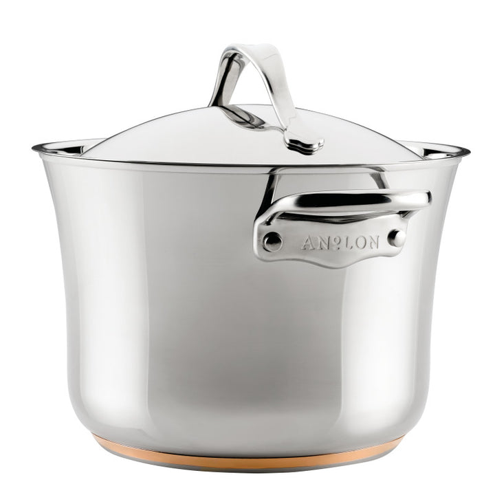 The 6.5-Quart Stockpot with Lid from Nouvelle Stainless features a smooth, reflective stainless steel surface, sturdy side handles, a hint of copper at the base, and the brand name engraved on the handle.