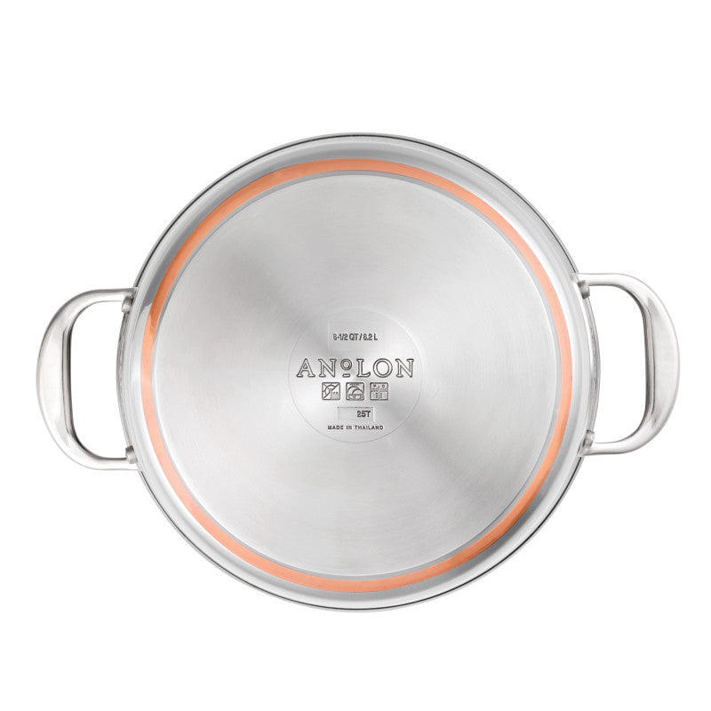 A 6.5-Quart Stockpot with Lid from the Nouvelle Stainless line is shown from above, displaying two side handles and an engraved bottom with brand details and an orange circular accent near the edge.