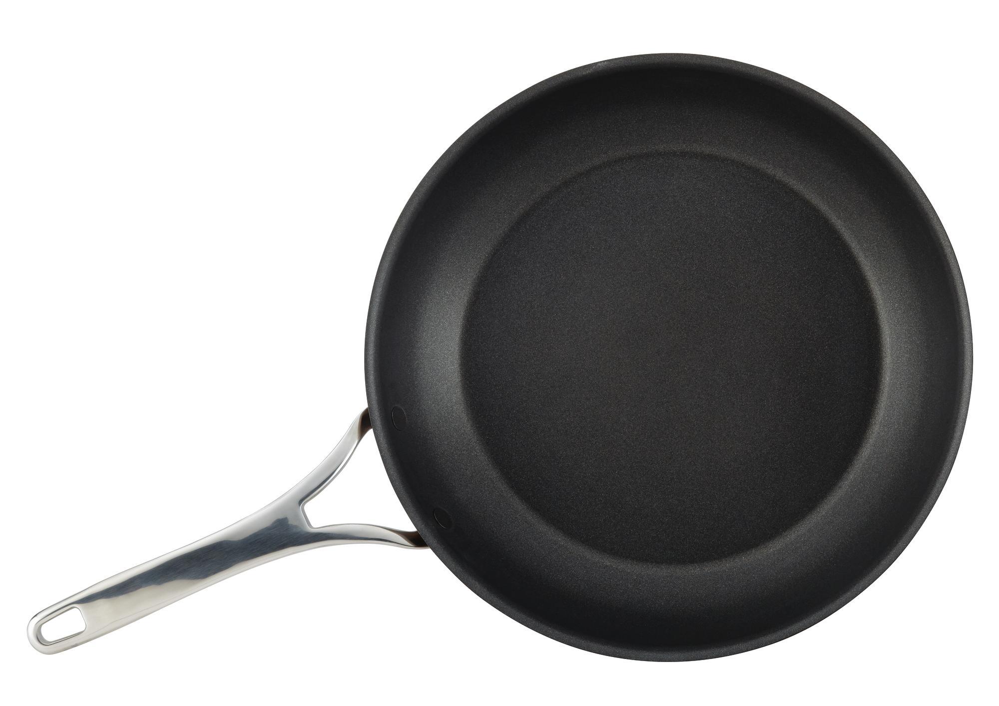A non-stick black frying pan with a shiny silver handle, set on a plain white background.
