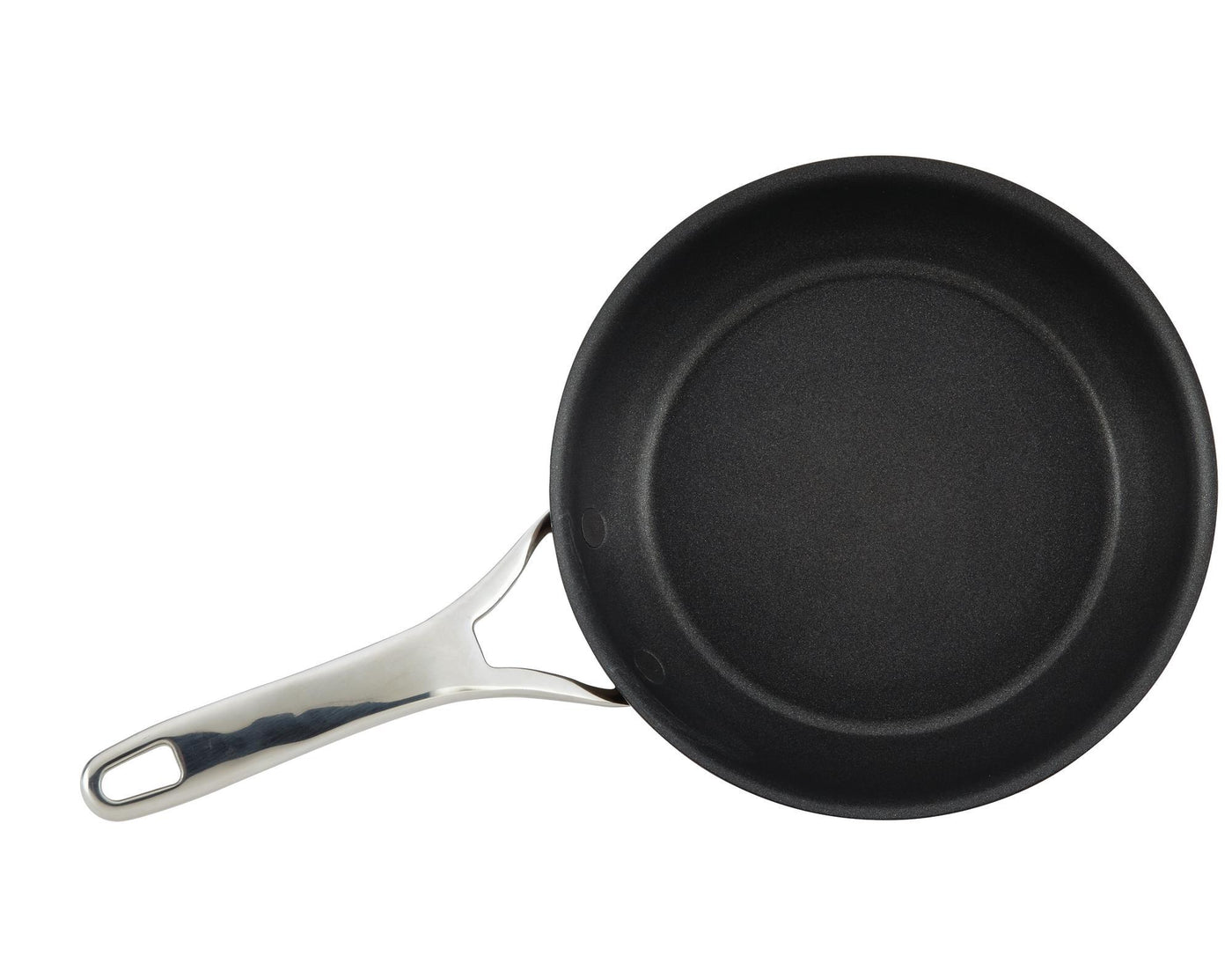 A non-stick frying pan with a silver handle is placed against a plain white background. The pan is positioned to the right, showcasing its circular shape and smooth black surface.