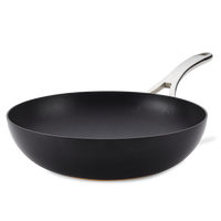 The Nouvelle Copper Luxe 12-Inch Stir Fry pan features a nonstick black surface, wide base, silver metal handle, and is induction suitable, shown on a plain white background.