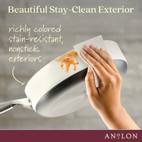 A hand wipes a white pan with a piece of paper towel, removing sauce stains. Text reads: Beautiful Stay-Clean Exterior and richly colored stain-resistant, nonstick exteriors. Anolon logo is at the bottom.