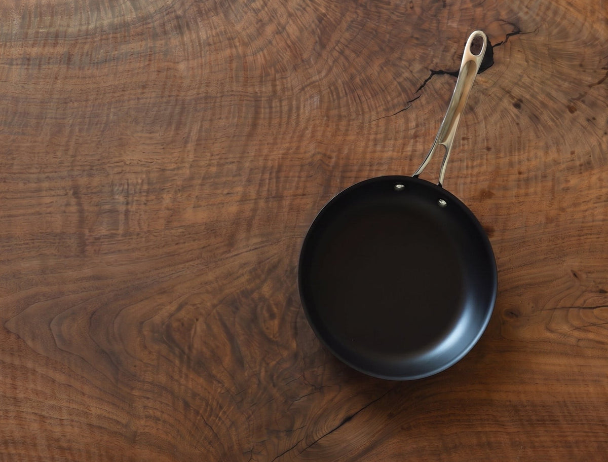 Aerial view of ten inch carbon steel pan on wood table