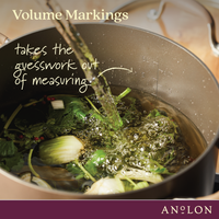 Volume markings, takes the guesswork out of measuring: water pouring into a bronze stockpot of fennel and herbs, with measurement lines inside