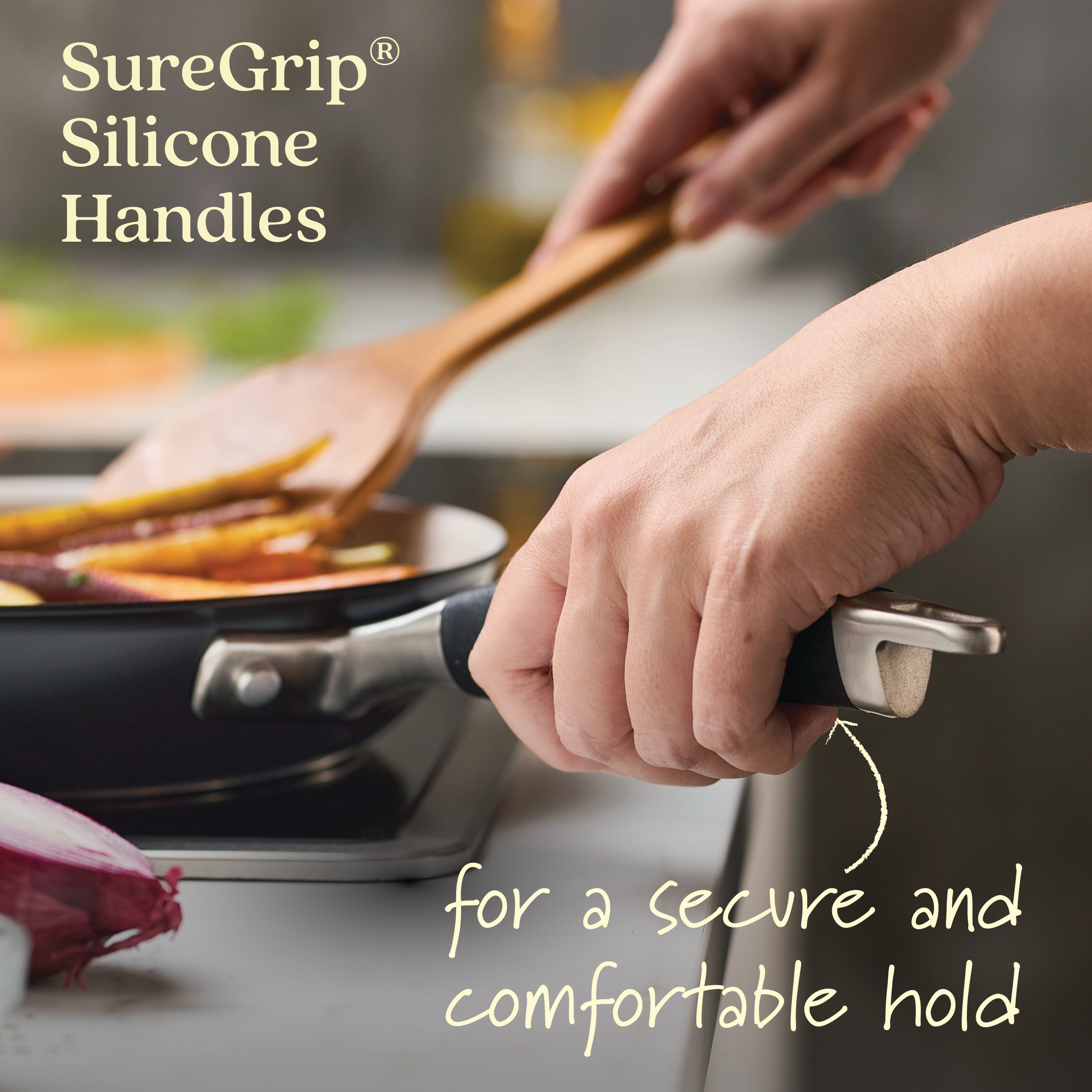 A person holds a pan from the Advanced Ceramic 2-Piece Nonstick Frying Pan Set with black SureGrip handles in one hand while stirring food with a wooden spatula. Text reads SureGrip® Silicone Handles and for a secure and comfortable hold. An onion on the countertop highlights its quality performance.