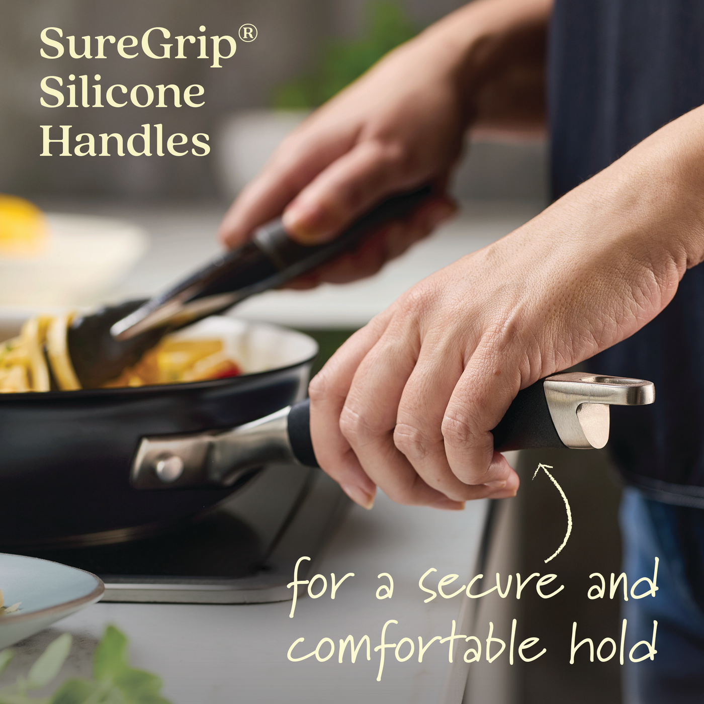 A person holds a 12-inch Ceramic Nonstick Frying Pan with silicone-handled tongs. The text reads, SureGrip® Silicone Handles for a secure and comfortable hold, highlighting the ease of use with Advanced Ceramic cookware.