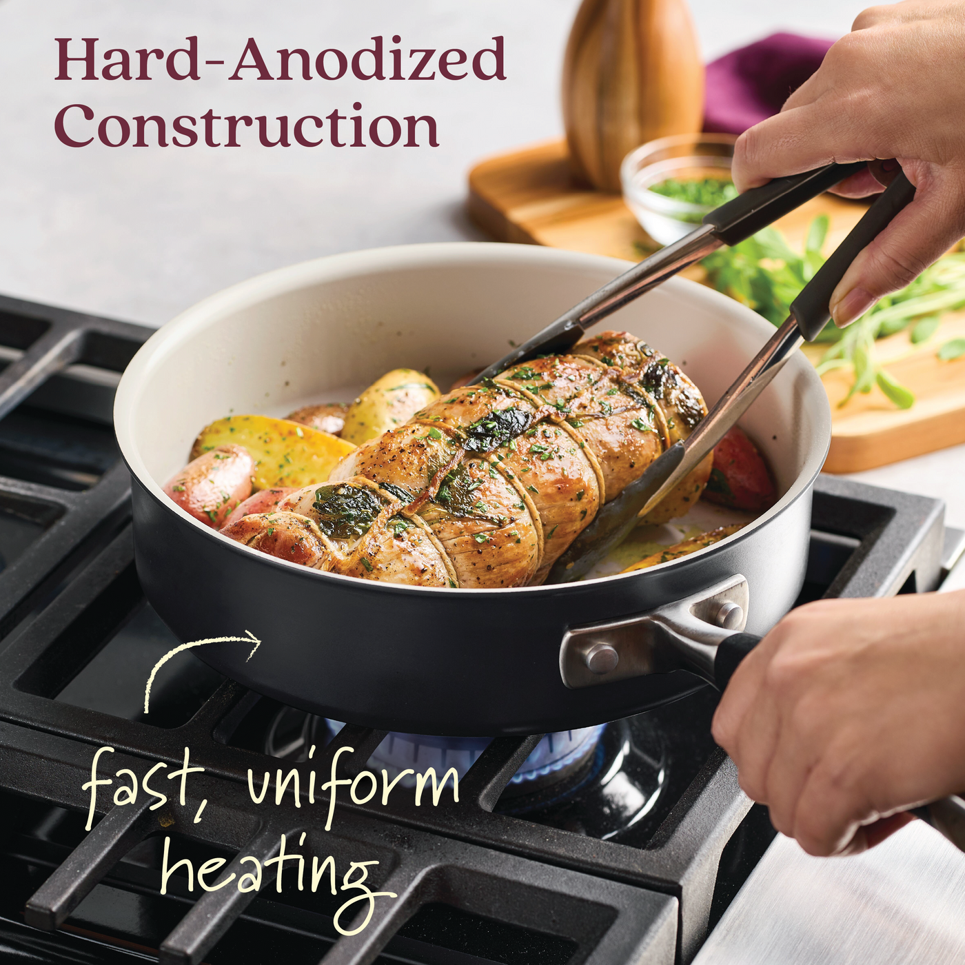 A person turns a rolled roast in the 10-Piece Ceramic Nonstick Cookware Set by Advanced Ceramic on a gas stove using tongs. The hard-anodized cookware with potatoes and herbs ensures fast, uniform heating. Text reads Hard-Anodized Construction.
