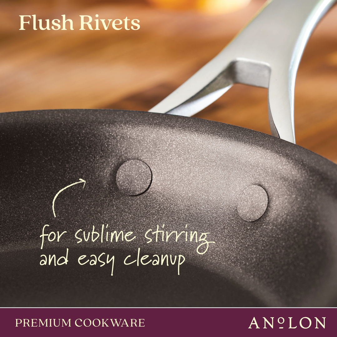 Close-up of the Nouvelle Copper Luxe 12-Inch Stir Fry pan, featuring flush rivets for smooth stirring and easy cleanup, with a metal handle. Induction suitable. Branding appears at the bottom.