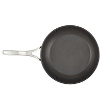 A nonstick frying pan with a silver handle is shown against a plain white background. The pan is round and appears unused, with a smooth black surface. The handle has a hole at the end for hanging.