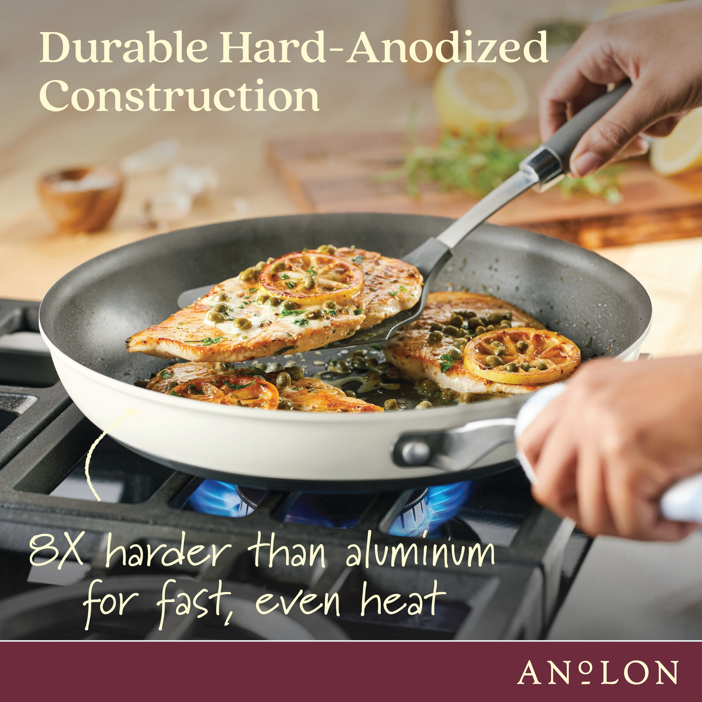 A person cooks seasoned chicken pieces in a hard-anodized frying pan over a blue flame on a stovetop. Text reads Durable Hard-Anodized Construction - 8X harder than aluminum for fast, even heat. Anolon logo is in the corner.