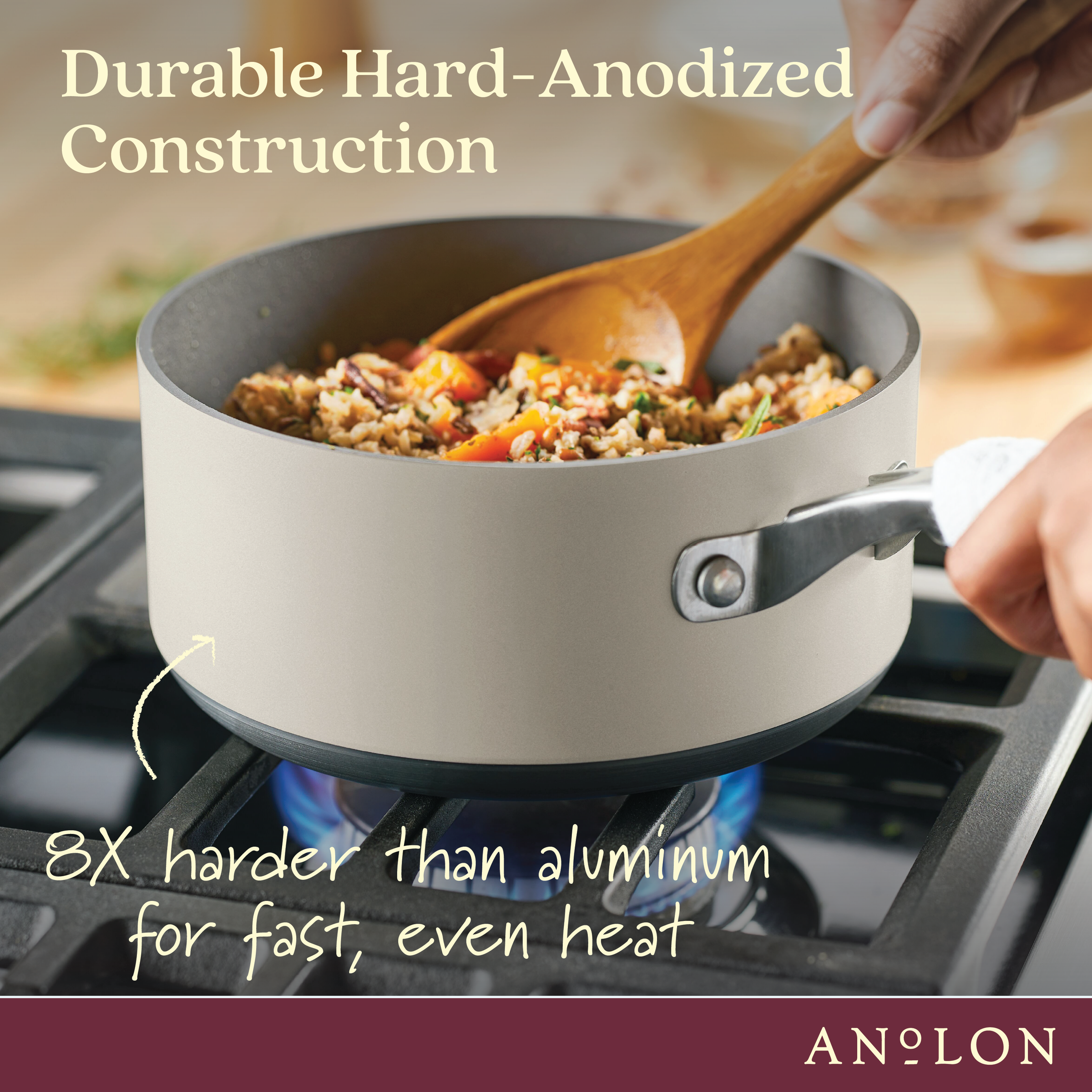 A person stirring a pan of fried rice with a wooden spoon on a gas stove. The pan is labeled as durable hard-anodized construction, 8 times harder than aluminum for fast, even heat. Anolon logo is at the bottom-right corner.