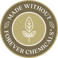 A circular, olive-green badge with a scalloped border. The center features a white line-art illustration of a leaf sprout, surrounded by the text "MADE WITHOUT FOREVER CHEMICALS," highlighting the PFAS-free and eco-conscious manufacturing of the cookware.