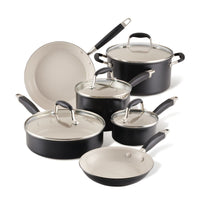The Advanced Ceramic 10-piece cookware set features ceramic nonstick interiors and glass lids. With sturdy handles and a compact design, this elegant black set on a white background is perfect for any modern kitchen.