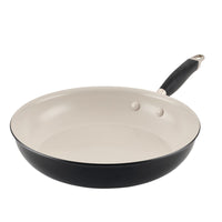 The Advanced Ceramic 12-inch black frying pan boasts a beige ceramic nonstick interior and a sleek black handle. Its smooth surface with two rivets ensures durability, while the silver-accented handle adds elegance. This pristine cookware is perfect for any kitchen.