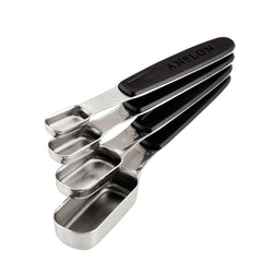 The Tools and Gadgets 4-Piece SureGrip® Magnetic Measuring Spoon Set features four stainless steel measuring spoons with sleek black magnetic handles. Neatly stacked together, these spoons range in size from tablespoon to teaspoon.