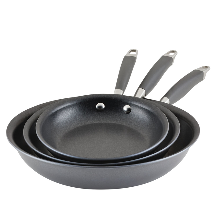 A set of three Advanced Home frying pans from the 3-Piece Nonstick Frying Pan Set is stacked neatly, showcasing varying sizes. Each pan is equipped with a handle that features both a hanging loop and an ergonomic grip. The side angle highlights the sleek, durable design of the Infinity Slide nonstick coating.