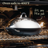 A 14-Inch Stainless Steel Domed Lid by Advanced Home, designed to fit any 14-inch pan, sits on an oven rack. Text above states "Cookware safe to 400°F", while the oven light illuminates the shiny, durable metal lid.