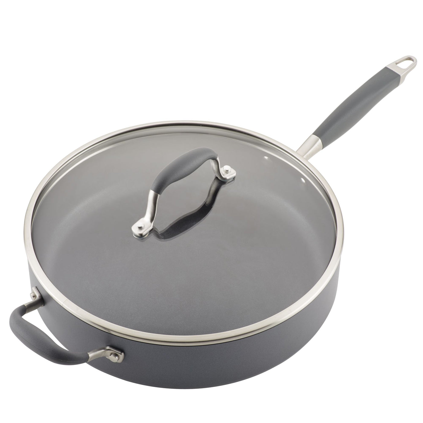 A nonstick skillet with a glass lid and dark gray rubber handles. The pan is round, with a long handle on one side and a short grip handle on the other. The lid has a stainless-steel rim and a matching handle.