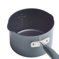 A black saucepan with a long handle and measurement markings on the inner side, indicating volume up to 1.5 quarts. The saucepan features a pouring lip on either side.