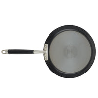 A black non-stick frying pan with a stainless steel bottom and a black handle, viewed from above. The pan has a smooth surface and a shiny finish.