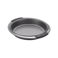 A round, non-stick metal baking pan with black silicone handles on each side. The word Anolon is embossed on the handles. The pan is placed against a plain white background.