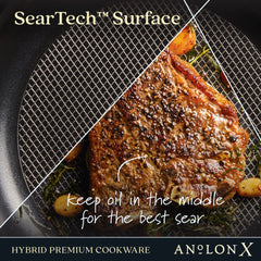 A piece of steak with seasoning is being seared in an AnolonX pan from the 7-Piece Hybrid Nonstick Cookware Set, utilizing SearTech™ technology which keeps oil centered for optimal searing. The image highlights this hybrid premium cookware by AnolonX, known for its ultra-durable nonstick surface that's safe for use with metal utensils.