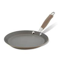 A non-stick frying pan with a smooth, gray surface and a brown handle. The pan has a metal loop at the end of the handle for hanging. The pan is shown on a white background.
