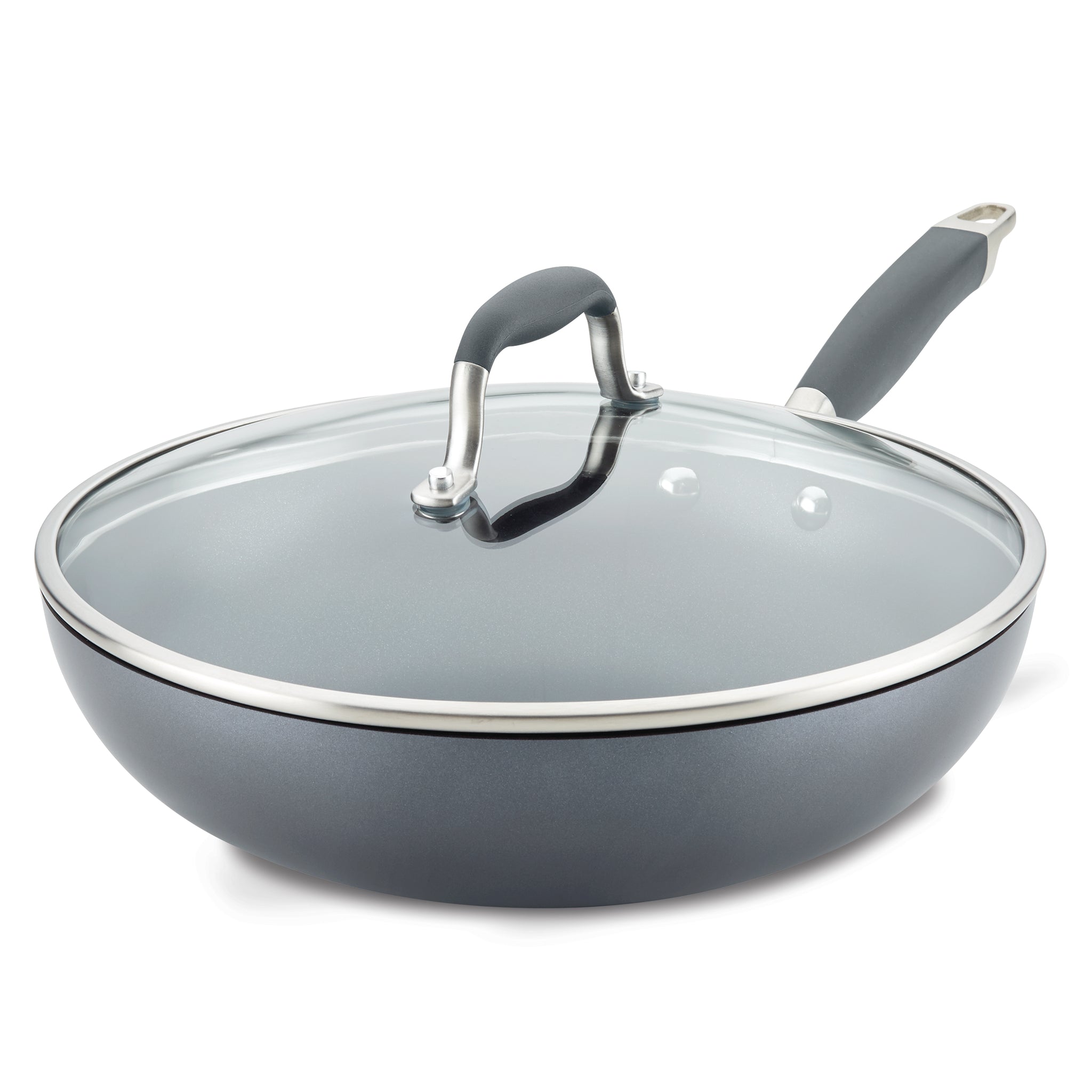 A gray non-stick frying pan with a clear glass lid and a black handle is shown. The lid has a metallic rim and handle. The pan is slightly angled, showcasing its deep design and shiny finish.